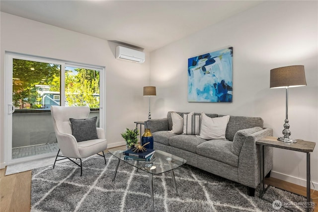 105B NW 39th St, Seattle, WA 98107 - living area with a wall mounted air conditioner, wood finished floors, and baseboards