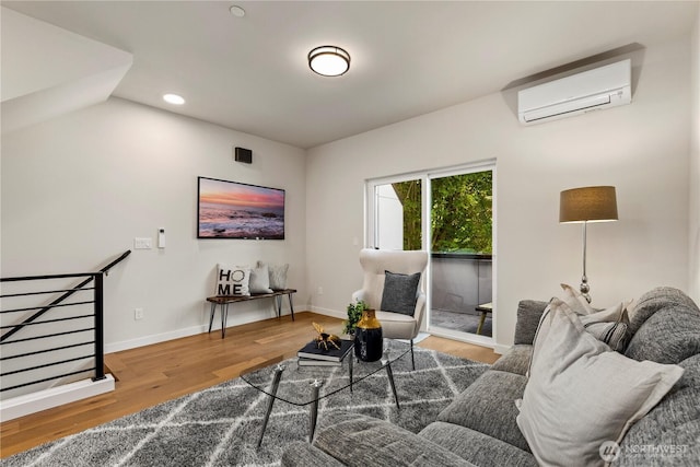 105B NW 39th St, Seattle, WA 98107 - living room featuring an AC wall unit, wood finished floors, recessed lighting, and baseboards