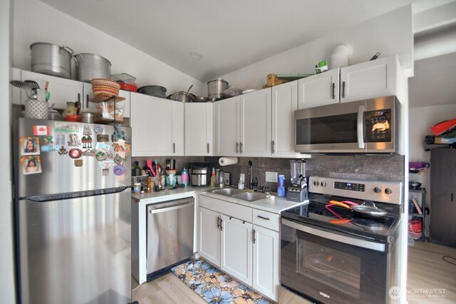 44094411 21st Ct SE, Lacey, WA 98503 - kitchen with appliances with stainless steel finishes, a sink, light countertops, decorative backsplash, and white cabinets