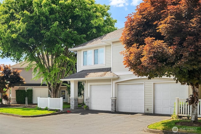 23503 55th Ave S, Kent, WA 98032 - view of front of home with asphalt driveway, an attached garage, a shingled roof, and stone siding