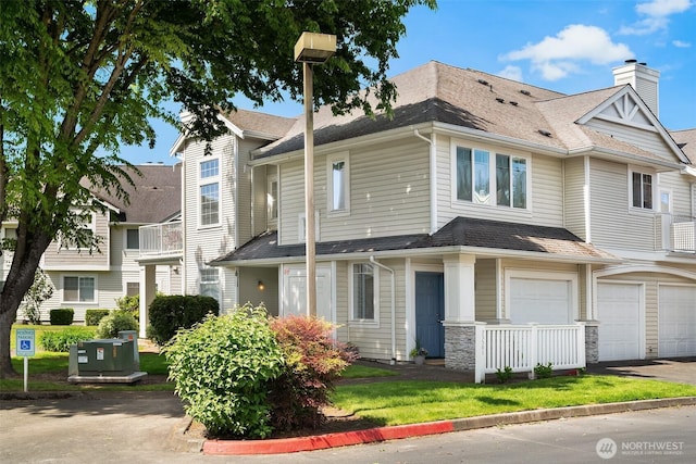 23503 55th Ave S, Kent, WA 98032 - townhome / multi-family property with a garage, a chimney, driveway, and roof with shingles