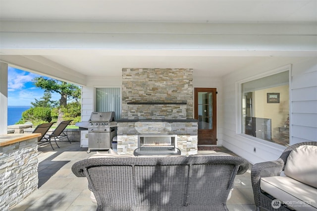 100 Willow Rd, Bellingham, WA 98225 - view of patio / terrace with a water view, an outdoor living space with a fireplace, and grilling area