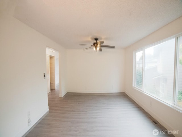 2840 SW 342nd St, Federal Way, WA 98023 - spare room with plenty of natural light, a ceiling fan, and light wood-type flooring
