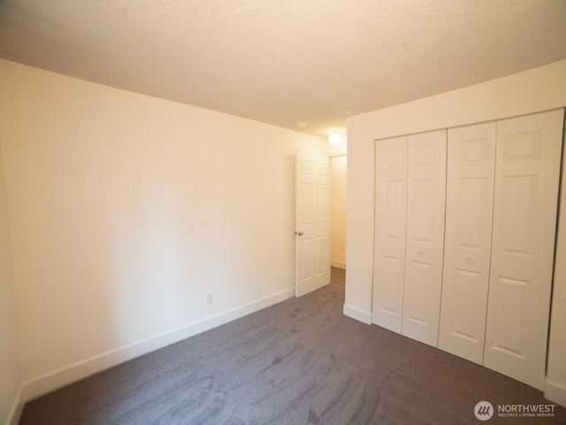 2840 SW 342nd St, Federal Way, WA 98023 - unfurnished bedroom featuring a textured ceiling, a closet, and dark colored carpet