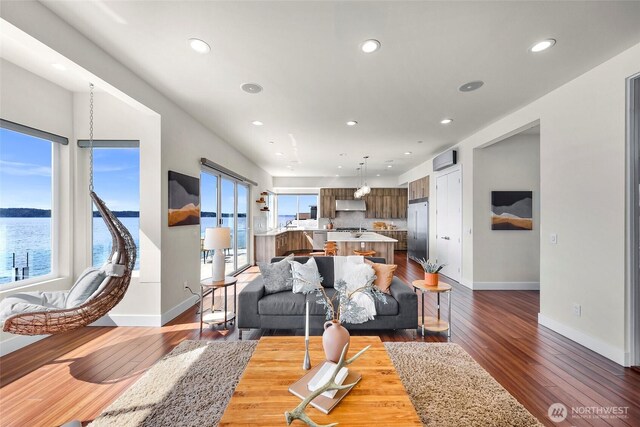 12065 30th Ave SW, Burien, WA 98146 - living room featuring baseboards, dark wood-style floors, recessed lighting, and a water view