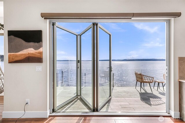 12065 30th Ave SW, Burien, WA 98146 - entryway featuring a water view, wood finished floors, and baseboards