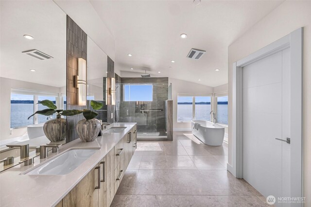12065 30th Ave SW, Burien, WA 98146 - full bath featuring a water view, a stall shower, a freestanding bath, double vanity, and recessed lighting