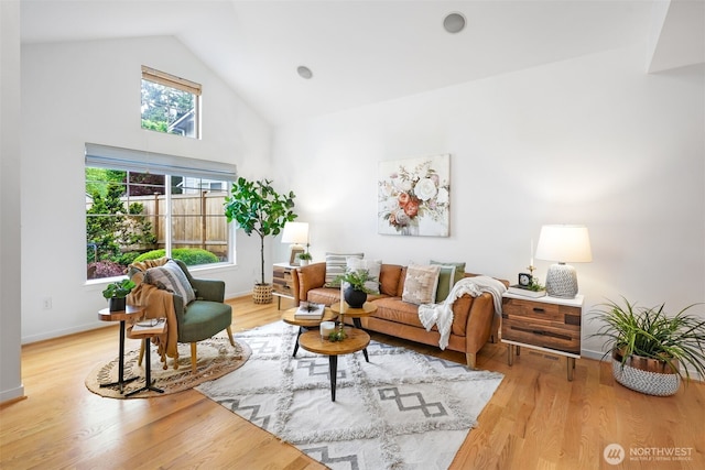10820 NE 144th Ct, Kirkland, WA 98034 - living room featuring high vaulted ceiling, light wood-type flooring, and baseboards