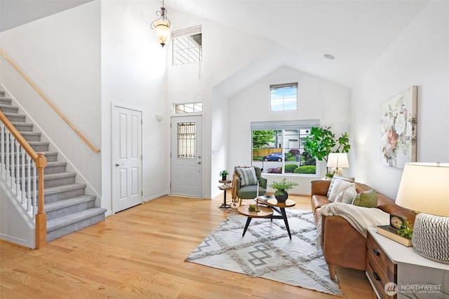 10820 NE 144th Ct, Kirkland, WA 98034 - living area with stairway, light wood-style floors, high vaulted ceiling, and baseboards