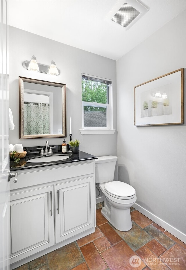 10820 NE 144th Ct, Kirkland, WA 98034 - full bath with vanity, toilet, baseboards, stone tile flooring, and a shower with curtain