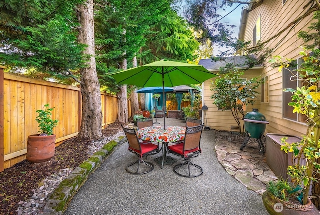 10820 NE 144th Ct, Kirkland, WA 98034 - fenced backyard with a patio, outdoor dining area, and a grill