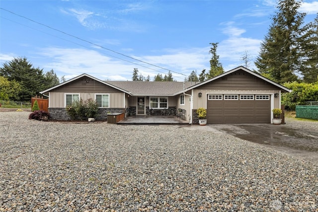 3001 163rd St E, Tacoma, WA 98446 - ranch-style home featuring driveway, an attached garage, stone siding, and covered porch