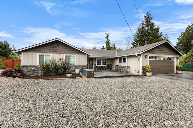 3001 163rd St E, Tacoma, WA 98446 - ranch-style home with a garage, board and batten siding, driveway, and stone siding