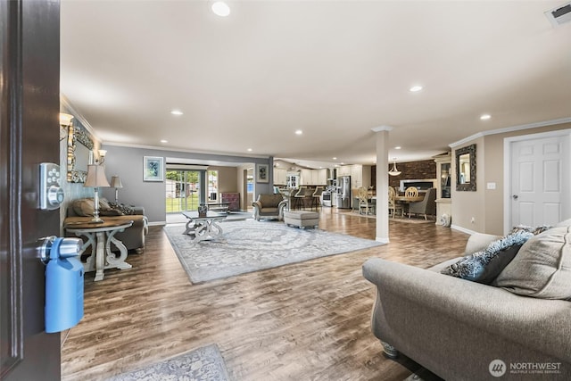 3001 163rd St E, Tacoma, WA 98446 - living area with ornamental molding, baseboards, recessed lighting, wood finished floors, and ornate columns