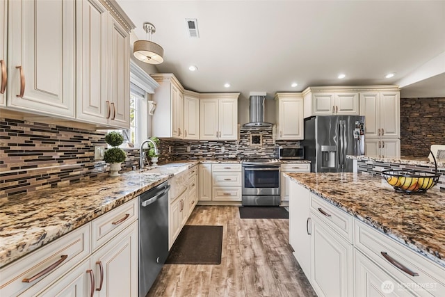 3001 163rd St E, Tacoma, WA 98446 - kitchen featuring stainless steel appliances, wall chimney range hood, backsplash, and recessed lighting