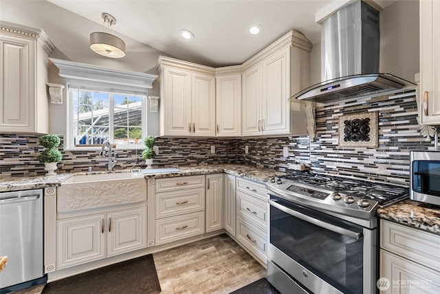 3001 163rd St E, Tacoma, WA 98446 - kitchen with wall chimney exhaust hood, stainless steel appliances, a sink, tasteful backsplash, and light stone counters