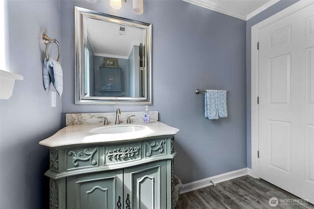 3001 163rd St E, Tacoma, WA 98446 - bathroom featuring ornamental molding, vanity, wood finished floors, and baseboards