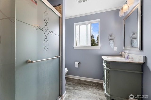 3001 163rd St E, Tacoma, WA 98446 - bathroom with vanity, wood finished floors, toilet, a shower with door, and baseboards