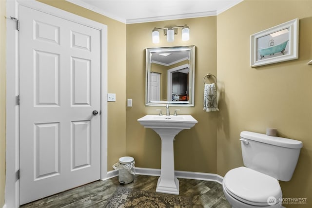 3001 163rd St E, Tacoma, WA 98446 - bathroom featuring toilet, wood finished floors, crown molding, baseboards, and a sink