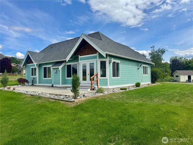 31 Apple Meadow Dr, Tonasket, WA 98855 - rear view of house with french doors, a yard, and roof with shingles