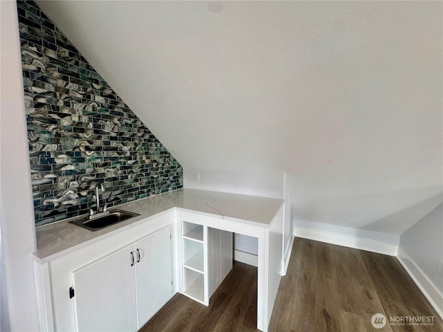 31 Apple Meadow Dr, Tonasket, WA 98855 - bar featuring a sink, lofted ceiling, dark wood-type flooring, backsplash, and baseboards