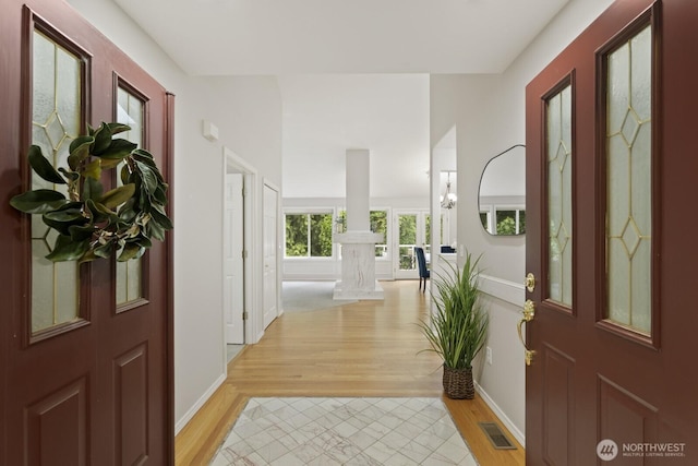 820 173rd Ave NE, Bellevue, WA 98008 - entrance foyer featuring light wood-style floors, ornate columns, and baseboards