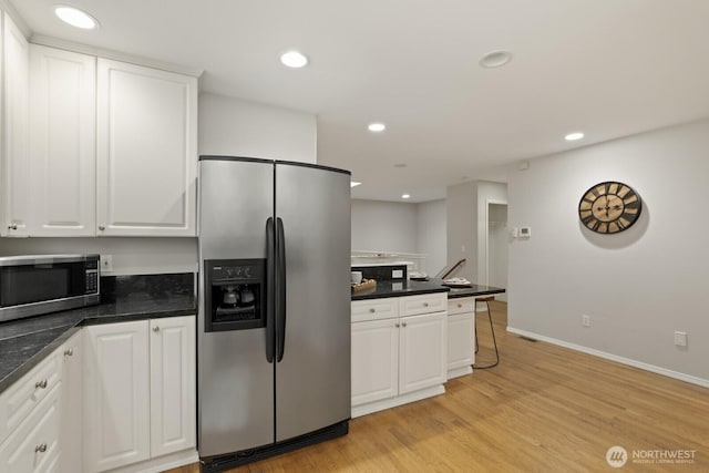 820 173rd Ave NE, Bellevue, WA 98008 - kitchen with appliances with stainless steel finishes, white cabinetry, dark countertops, light wood-style flooring, and recessed lighting
