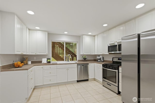 820 173rd Ave NE, Bellevue, WA 98008 - kitchen featuring stainless steel appliances, a sink, white cabinets, recessed lighting, and light tile patterned floors