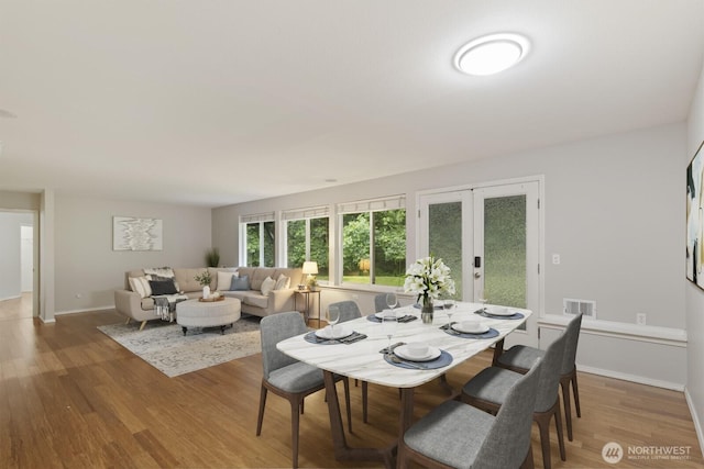 820 173rd Ave NE, Bellevue, WA 98008 - dining room with french doors, wood finished floors, and baseboards