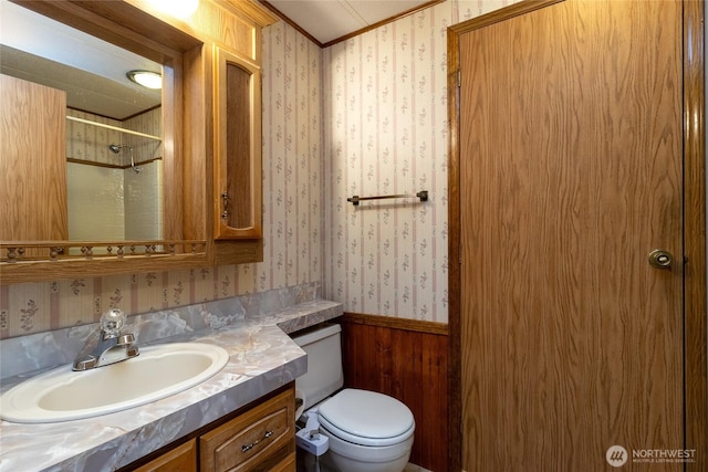 545 NE Troutdale Ave, College Place, WA 99324 - bathroom with wallpapered walls, toilet, a wainscoted wall, vanity, and wooden walls