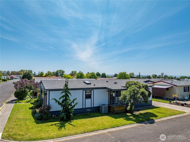 545 NE Troutdale Ave, College Place, WA 99324 - view of front facade featuring a front lawn, central air condition unit, and a shingled roof