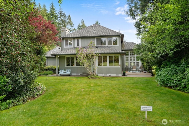 5426 Quail Run, Blaine, WA 98230 - back of property with a wooden deck, a chimney, a yard, and roof with shingles