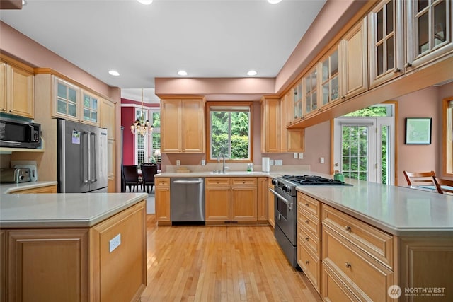 5426 Quail Run, Blaine, WA 98230 - kitchen featuring premium appliances, a peninsula, light countertops, a chandelier, and recessed lighting