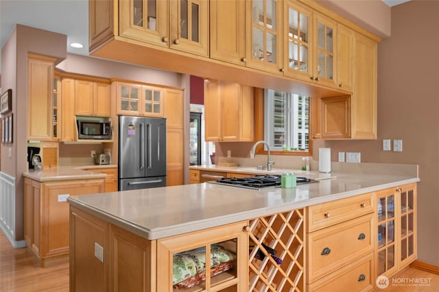 5426 Quail Run, Blaine, WA 98230 - kitchen featuring stainless steel appliances, glass insert cabinets, a peninsula, light countertops, and recessed lighting