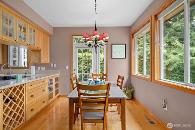 5426 Quail Run, Blaine, WA 98230 - dining space featuring light wood-type flooring, plenty of natural light, a chandelier, and baseboards