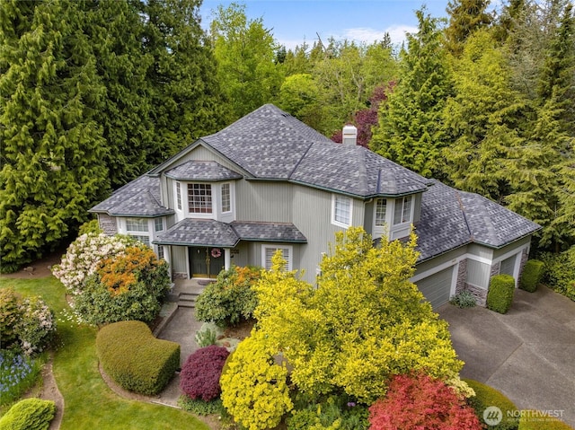 5426 Quail Run, Blaine, WA 98230 - traditional home with a chimney, concrete driveway, and an attached garage