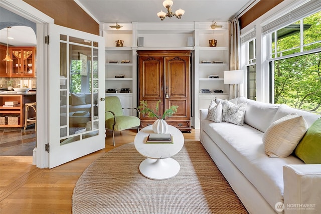 903 W Newell St, Seattle, WA 98119 - living room with a chandelier, light wood finished floors, and crown molding