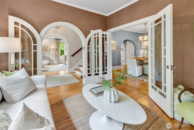 903 W Newell St, Seattle, WA 98119 - living room with arched walkways, wood finished floors, ornamental molding, stairway, and french doors