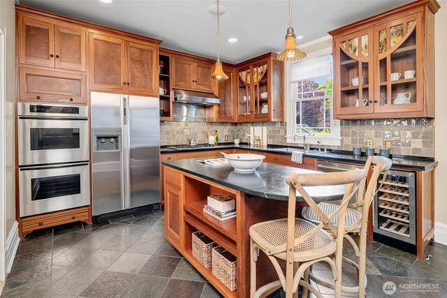 903 W Newell St, Seattle, WA 98119 - kitchen featuring open shelves, appliances with stainless steel finishes, dark countertops, under cabinet range hood, and recessed lighting
