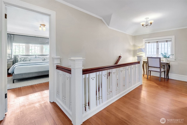 903 W Newell St, Seattle, WA 98119 - corridor with an upstairs landing, wood finished floors, plenty of natural light, a chandelier, and crown molding