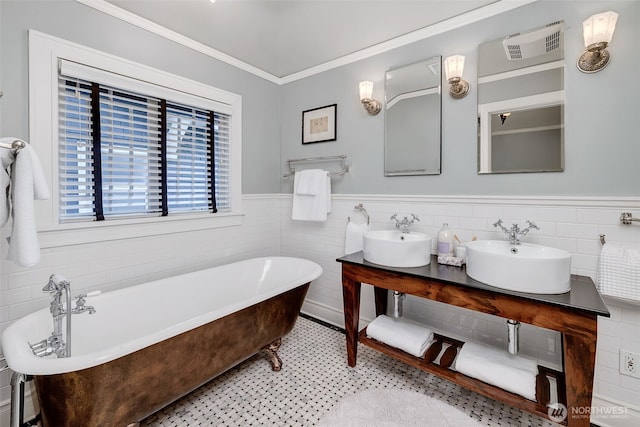 903 W Newell St, Seattle, WA 98119 - full bath featuring ornamental molding, double vanity, a freestanding bath, wainscoting, and tile walls