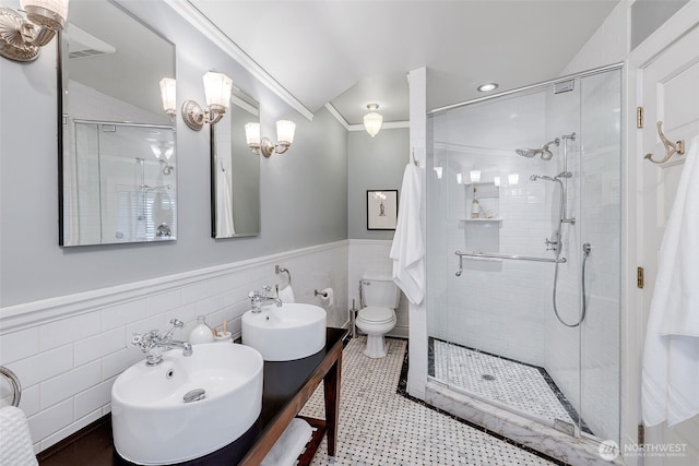 903 W Newell St, Seattle, WA 98119 - full bath featuring crown molding, a stall shower, a wainscoted wall, tile walls, and double vanity