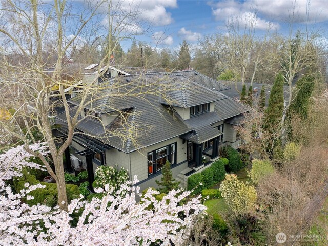903 W Newell St, Seattle, WA 98119 - view of home's exterior with a shingled roof, a chimney, and view of wooded area