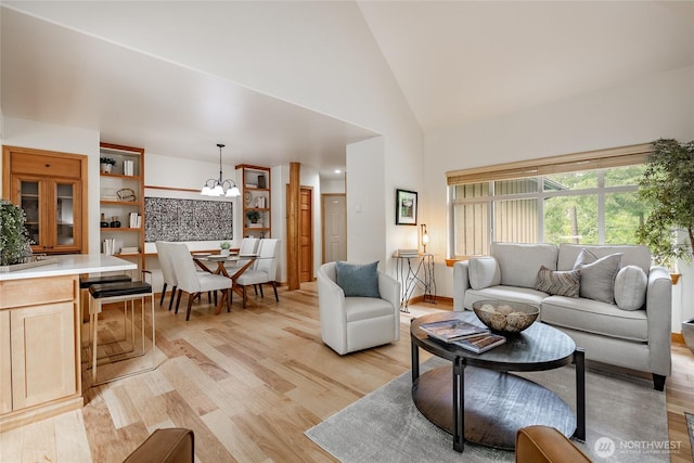 5430 Snow Goose Ln Unit 202, Blaine, WA 98230 - living room with a chandelier, light wood-style flooring, and high vaulted ceiling