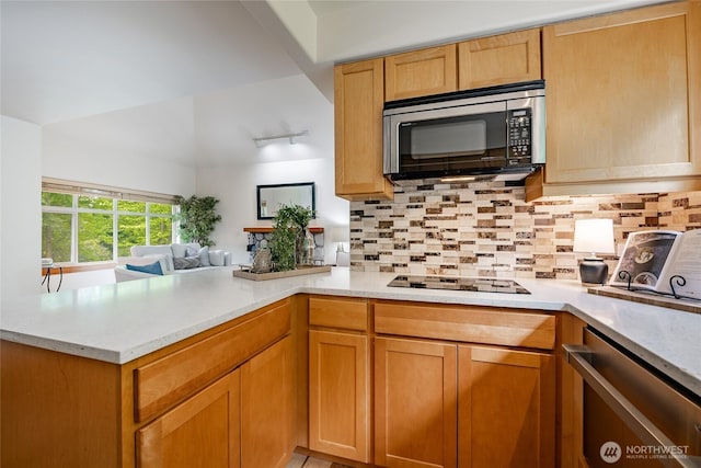 5430 Snow Goose Ln Unit 202, Blaine, WA 98230 - kitchen with black electric stovetop, a peninsula, tasteful backsplash, open floor plan, and dishwasher