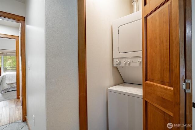 5430 Snow Goose Ln Unit 202, Blaine, WA 98230 - laundry room featuring stacked washer / dryer and light tile patterned flooring