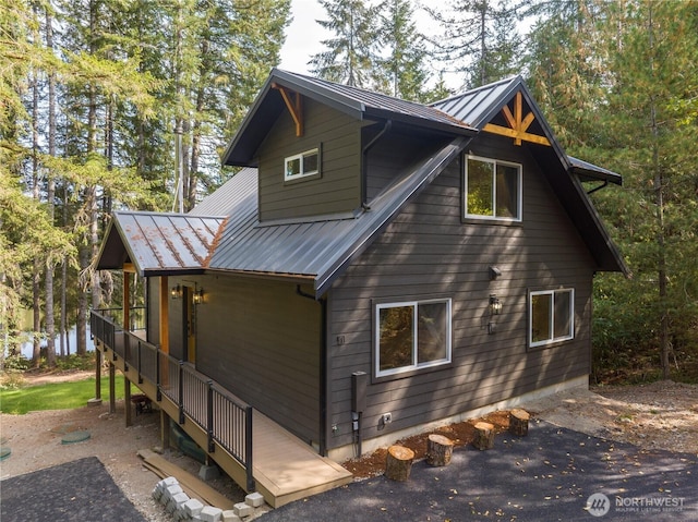 view of side of home with metal roof