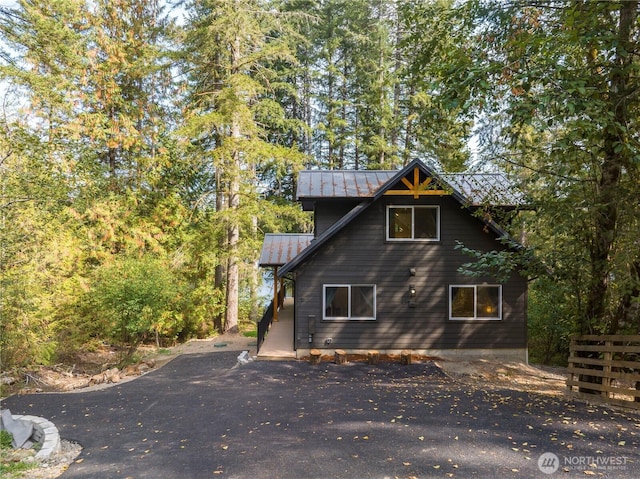 view of property exterior featuring a standing seam roof and metal roof