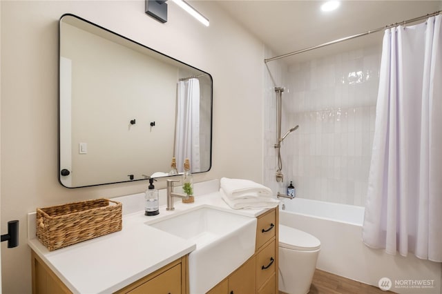 full bath featuring vanity, toilet, shower / bath combination with curtain, and wood finished floors