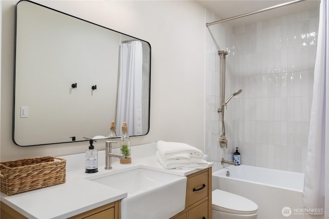 full bathroom with vanity, shower / tub combo with curtain, and toilet